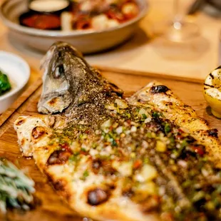 Whole Branzino herb stuffed with spinach, calabrian chilis and lemon.