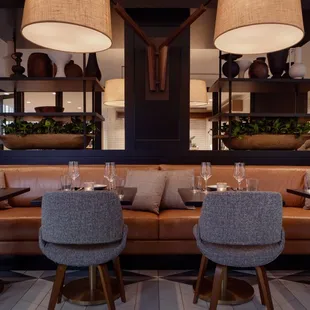 Comfortable leather banquets and soft lighting fill the dining room.