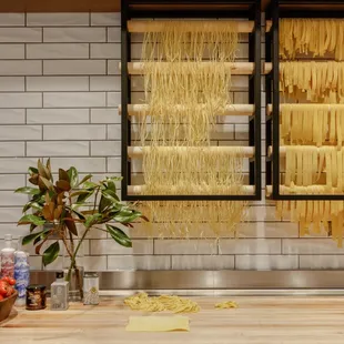 Menu features fresh made pasta daily, displayed in glass-wall pasta room.