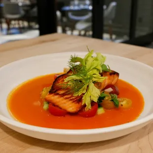 Roasted Ora King salmon with heirloom tomatoes in an acqua pazza broth.