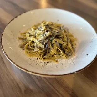 a plate of pasta with mushrooms