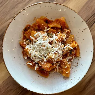a bowl of pasta with parmesan cheese