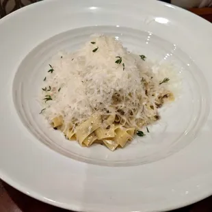 a plate of pasta and parmesan