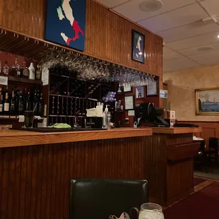 a bar with wine glasses on the counter