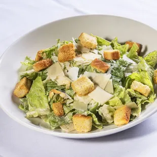 a bowl of salad with croutons