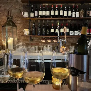 several glasses of wine on a bar