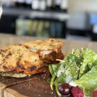 Panuozzo with milanese and eggplant  and spinach salad