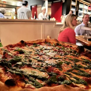 a large pizza on a table in a restaurant