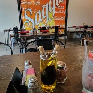 a wooden table with a glass of beer and salt and pepper shakers