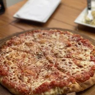 a pizza on a wooden platter