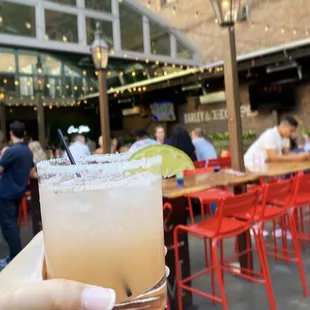 a hand holding a margarita