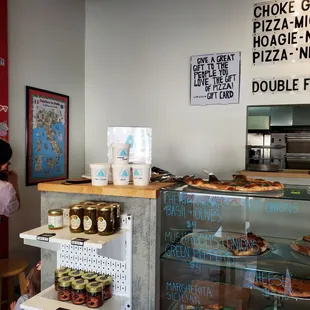 Black used/unused mask on counter, food less than a few feet away