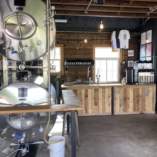 a man standing in front of a stainless steel tank