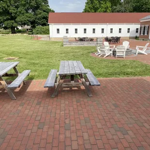 picnic tables on a brick patio