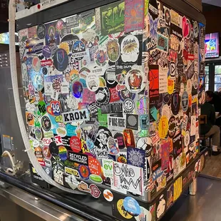 a refrigerator covered in stickers