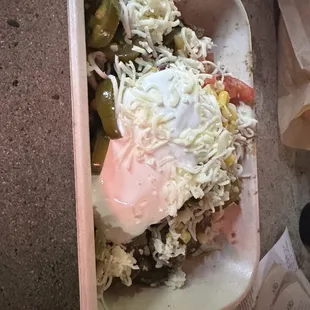 Burrito bowl with steak, fajita veggies, corn, sour cream, cheese, jalapeños.
