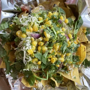 Nachos!   All of our favorite ingredients, a mountain  topped with lots of cilantro.