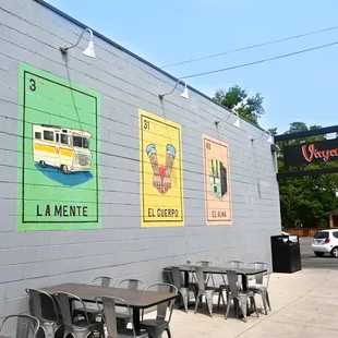 a row of tables and chairs outside a restaurant