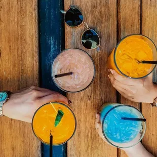 three people holding drinks