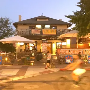 a woman riding a bike in front of a restaurant