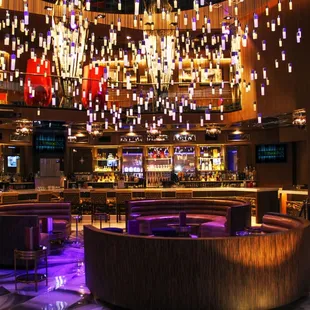 a circular lounge with a bar in the background
