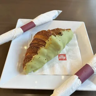 Pistachio croissant dipped in matcha icing!