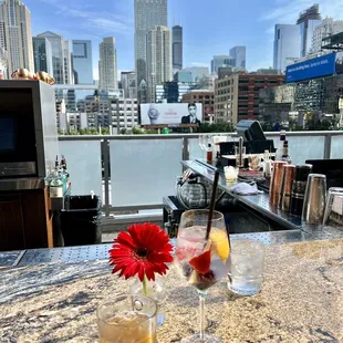 a view of a city from a rooftop bar