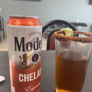 a can of mode cheelad and a glass of beer