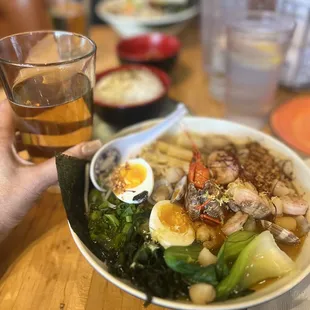a person holding a glass of beer