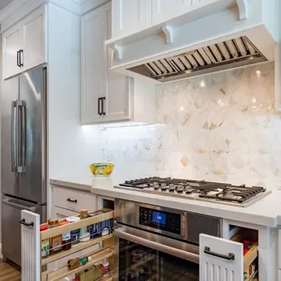 a kitchen with white cabinets and stainless steel appliances