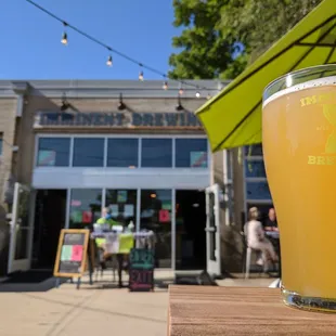 a glass of beer on a table outside