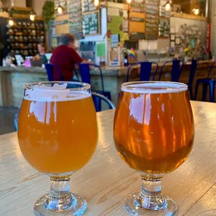 two glasses of beer on a table