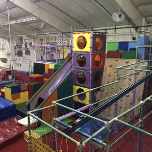 Climbing structure, foam pit, and zip line