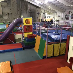 Climbing structure used during open play. Monster Mountain rock wall in background.