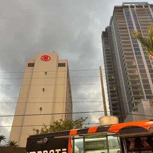 a food truck parked in front of a tall building