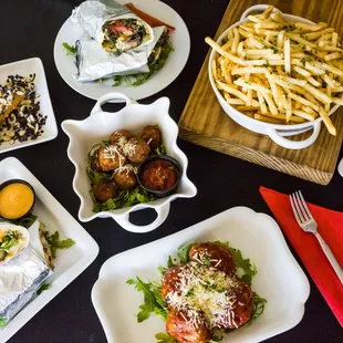 a variety of plates of food on a table