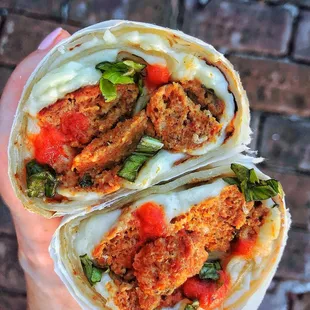 a person holding a burrito