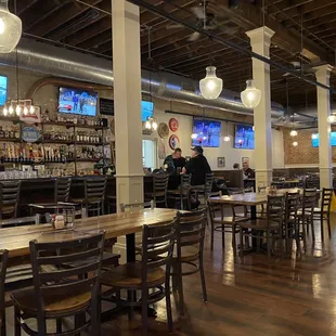 a restaurant with wooden tables and chairs