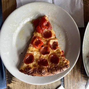 a slice of pepperoni pizza on a plate
