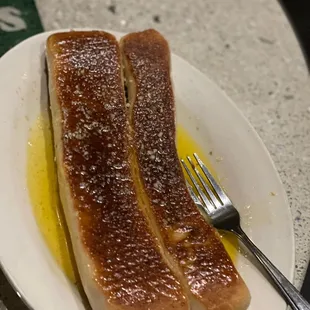 "Breadsticks" drowning in melted butter.