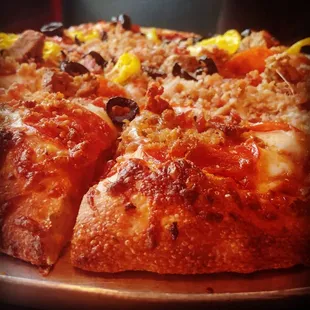 10 inch meat pizza with banana peppers and black olives added to half. Great for two or three people.