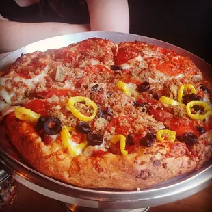 10 inch meat pizza with banana peppers and black olives added to half. Great for two or three people.