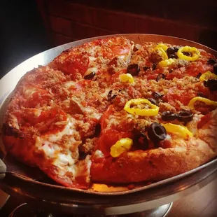 10 inch meat pizza with banana peppers and black olives added to half. Great for two or three people.