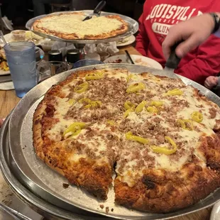 Sausage and Banana Pepper Pizza in front and Cheese Pizza in back