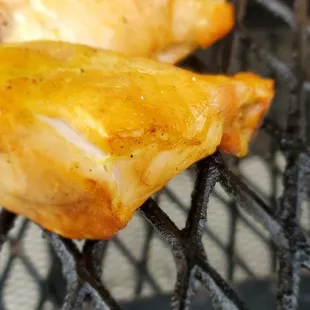 chicken wings cooking on a grill