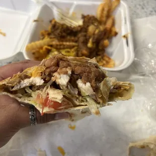 The inside of the chicken burrito and the chili cheese fries in the process of devouring them lol