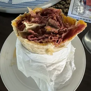 Pastrami burrito, you can ask to add hot sauce. Sometimes I add mustard and pickles. Definitely big enough for two servings, all for $10