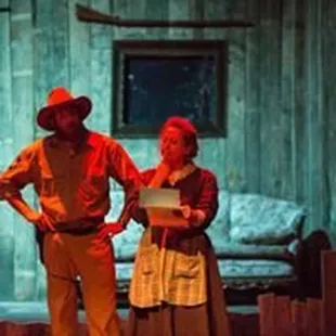 a man and a woman standing on stage