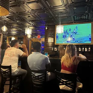 a group of people sitting at a bar