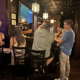 a group of people at a bar